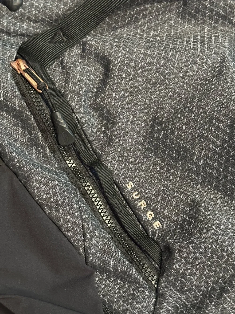 The North Face Surge Backpack in TNF Black Heather Copper/TNF Black